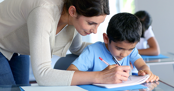 teacher helping student