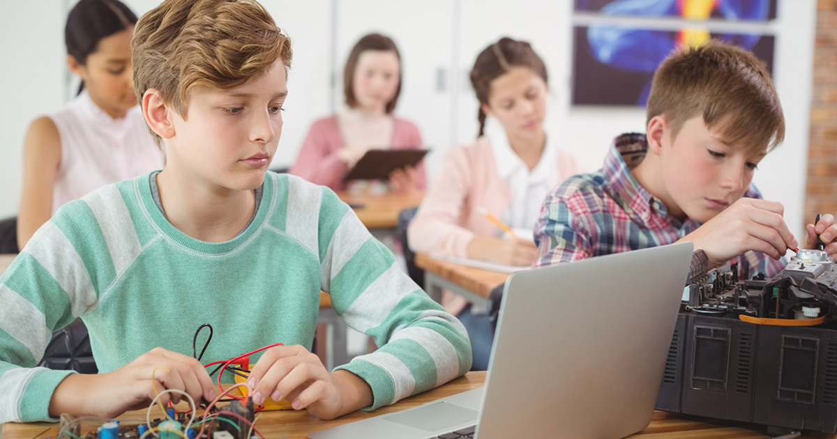 Middle school students working at a learning station