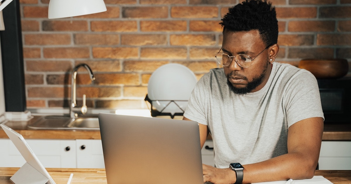 Guy studying on his laptop in office environment