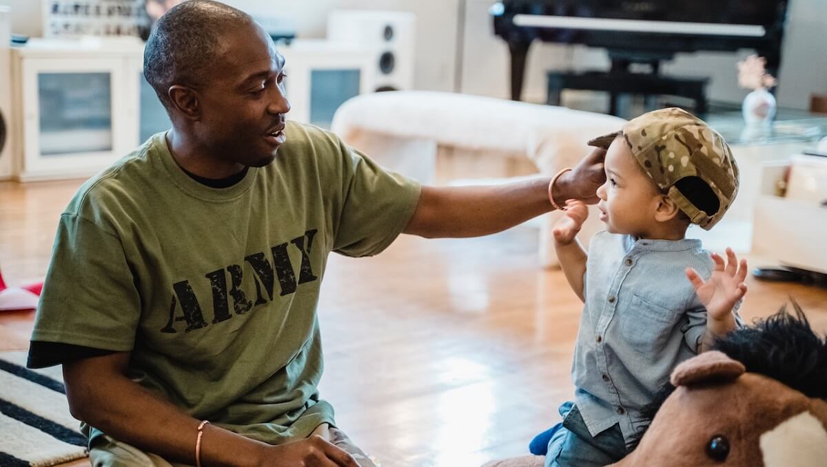 Military adult interacting with child