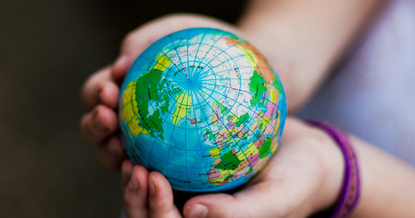Girl holding miniature globe