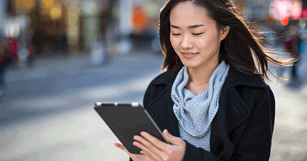 Woman holding a tablet outside on the go