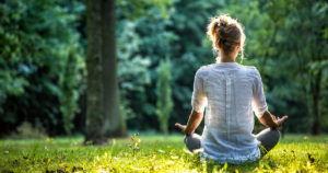 A teacher practicing self-care by meditating
