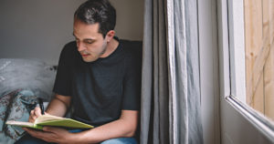 A teacher writing in his journal