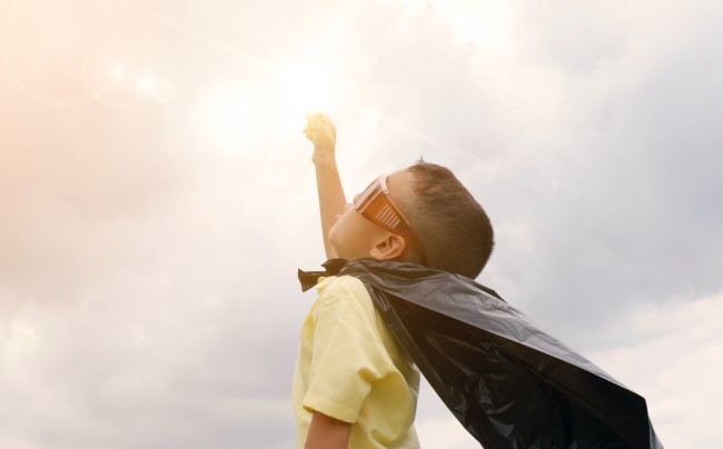 Boy pretending to be superhero