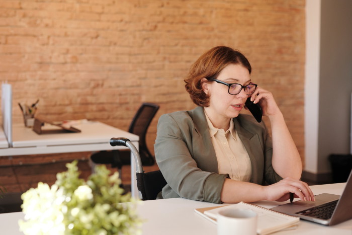 Woman on phone and laptop