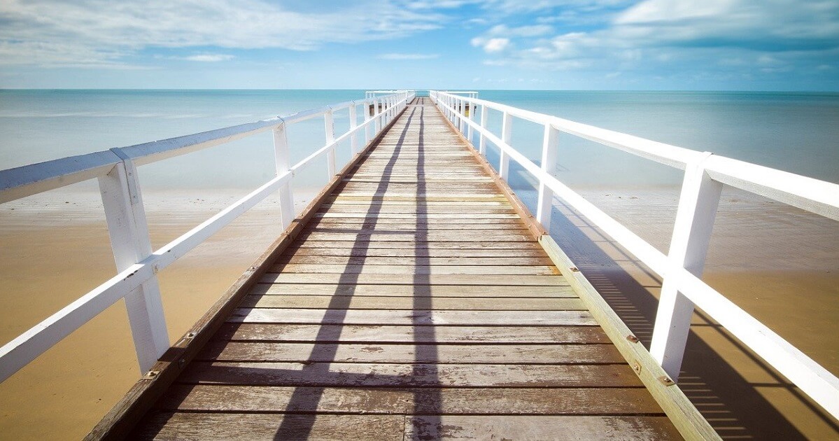 A long beach dock extending into the sea