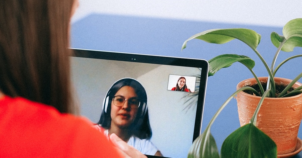 Two ladies talking on a video chat using a laptop