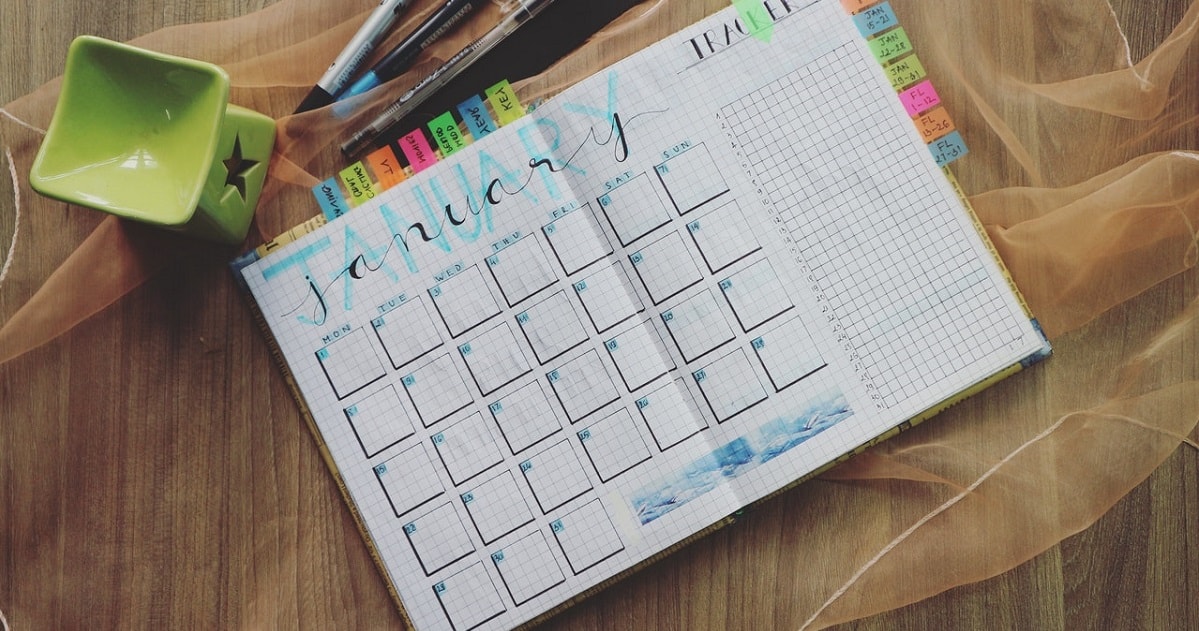 Planner with markers and pens nearby