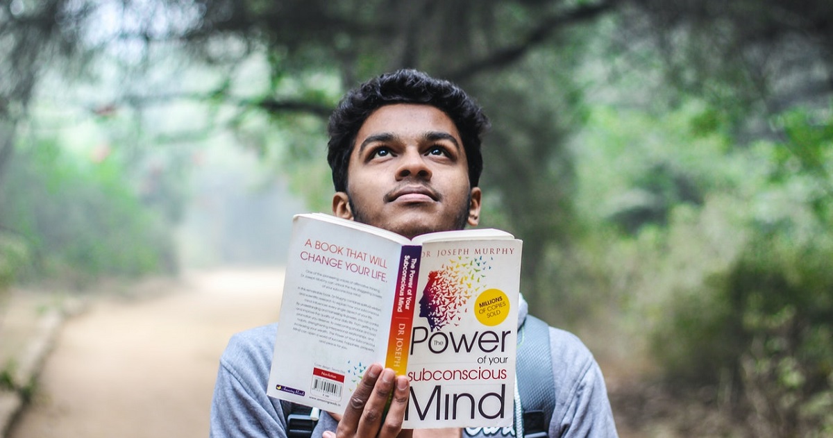 Student looks up while reading book