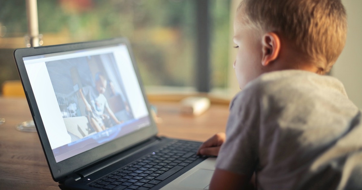 Kid staring at laptop screen