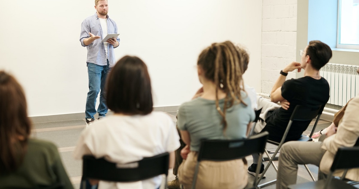 Students listening to speaker in a classroom