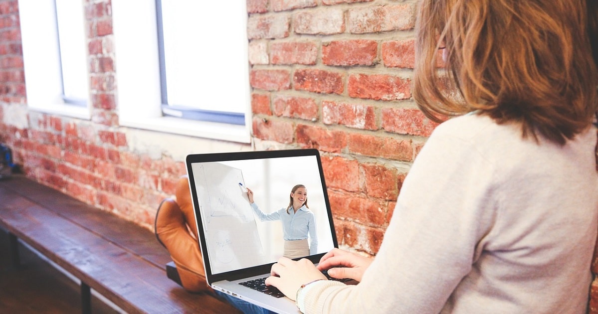 Woman resting feet while using laptop